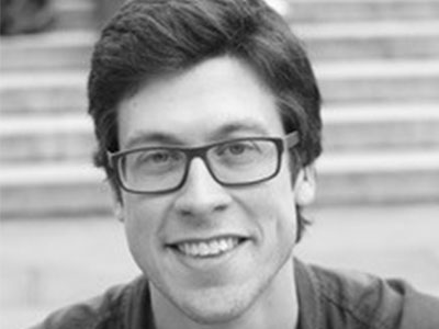 Mark Biggins wearing glasses and smiling at the camera